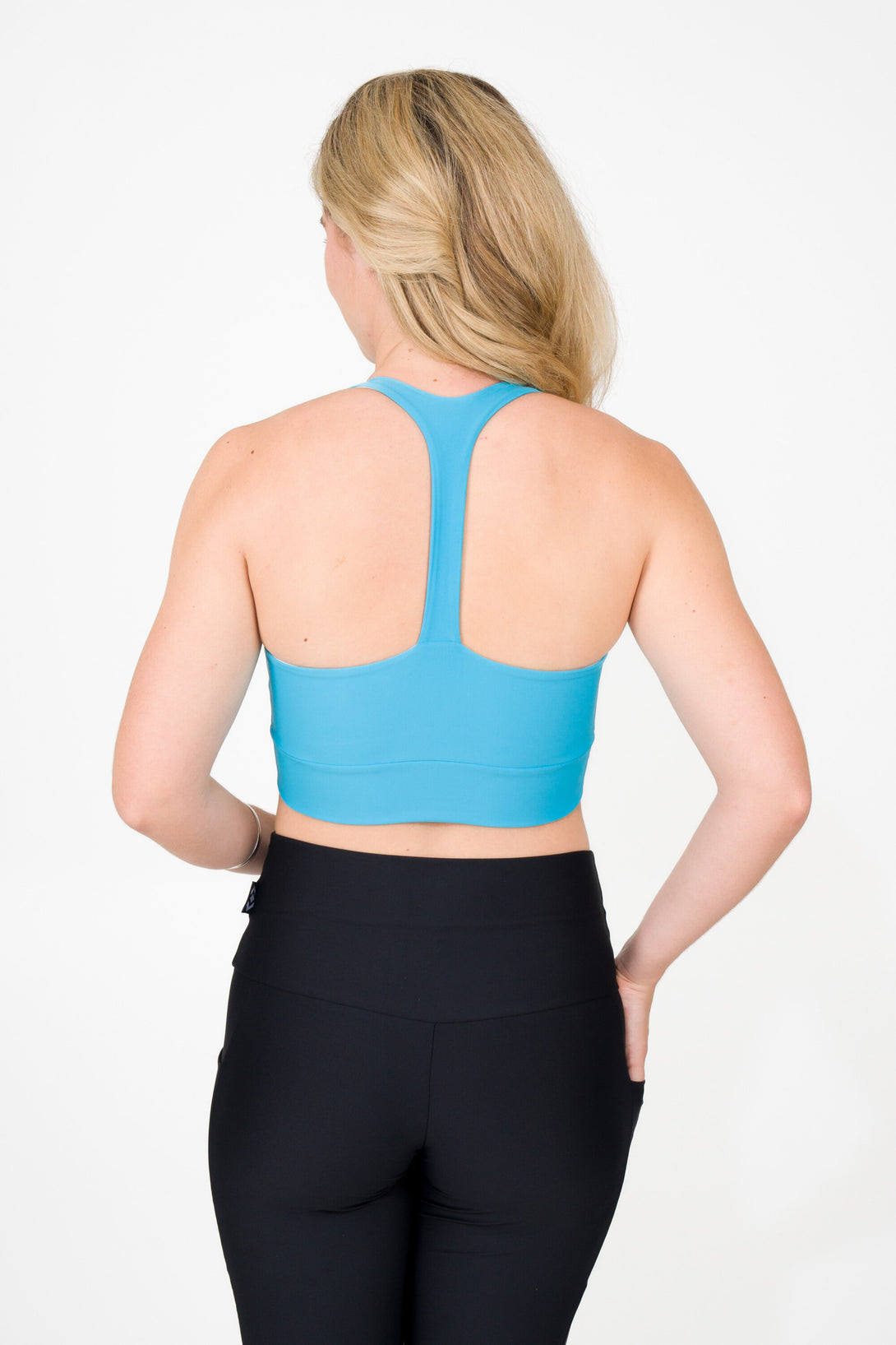 blonde woman wearing aqua cross over crop top activewear for gym and fitness