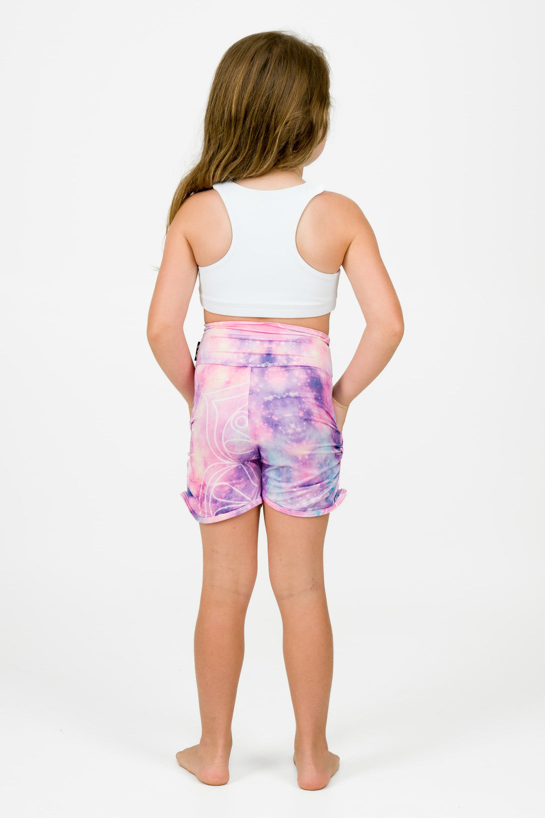 Young girl wearing kids jogger shorts in a bright playful purple star print 