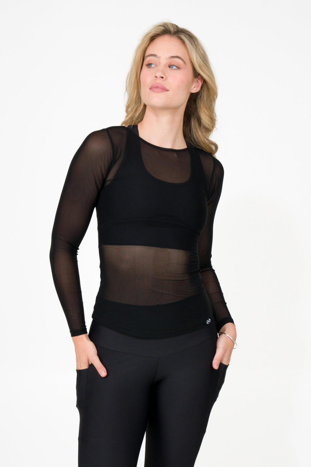 blonde woman wearing black net fitted long sleeve activewear and leisure wear shirt