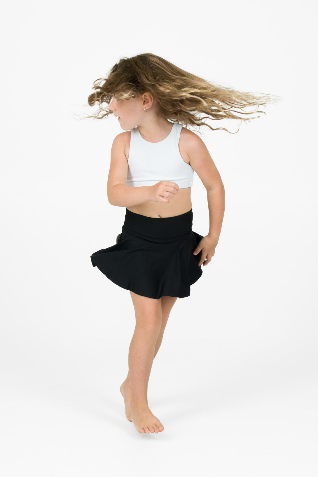 Young girl wearing exotica activewear designed for performance dancing simple skort design full coverage in black colour