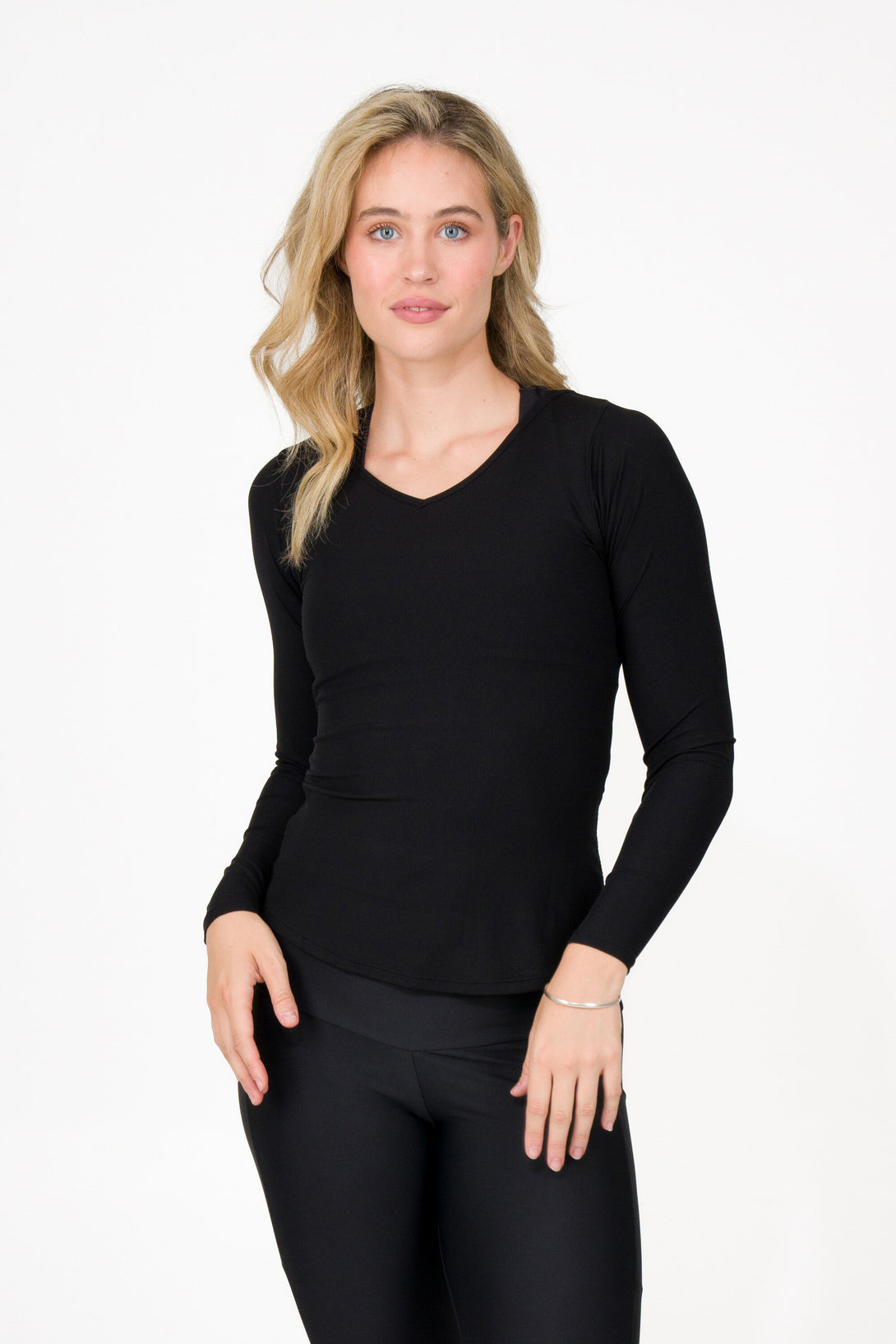 Woman wearing activewear black rib knit fitted long sleeve V neck shirt